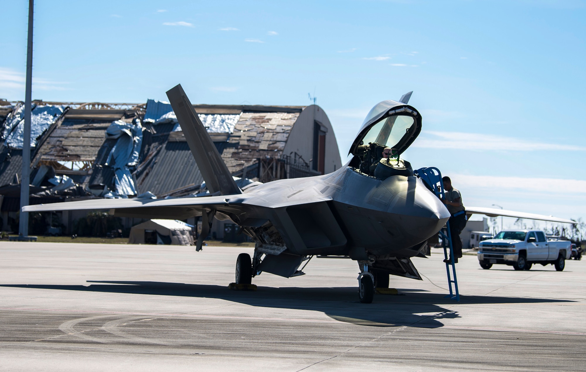 A pilot from the 27th fighter Squadron, Langley, Virginia, prepares to fly an F-22 Raptor fighter aircraft from Tyndall Air Force Base, Florida, following Hurricane Michael, October 24, 2018. Support personnel from Tyndall and other bases are working to repair base infrastructure and build bare-bones facilities after Hurricane Michael.(U.S. Air Force photo by Airman 1st Class Kelly Walker)