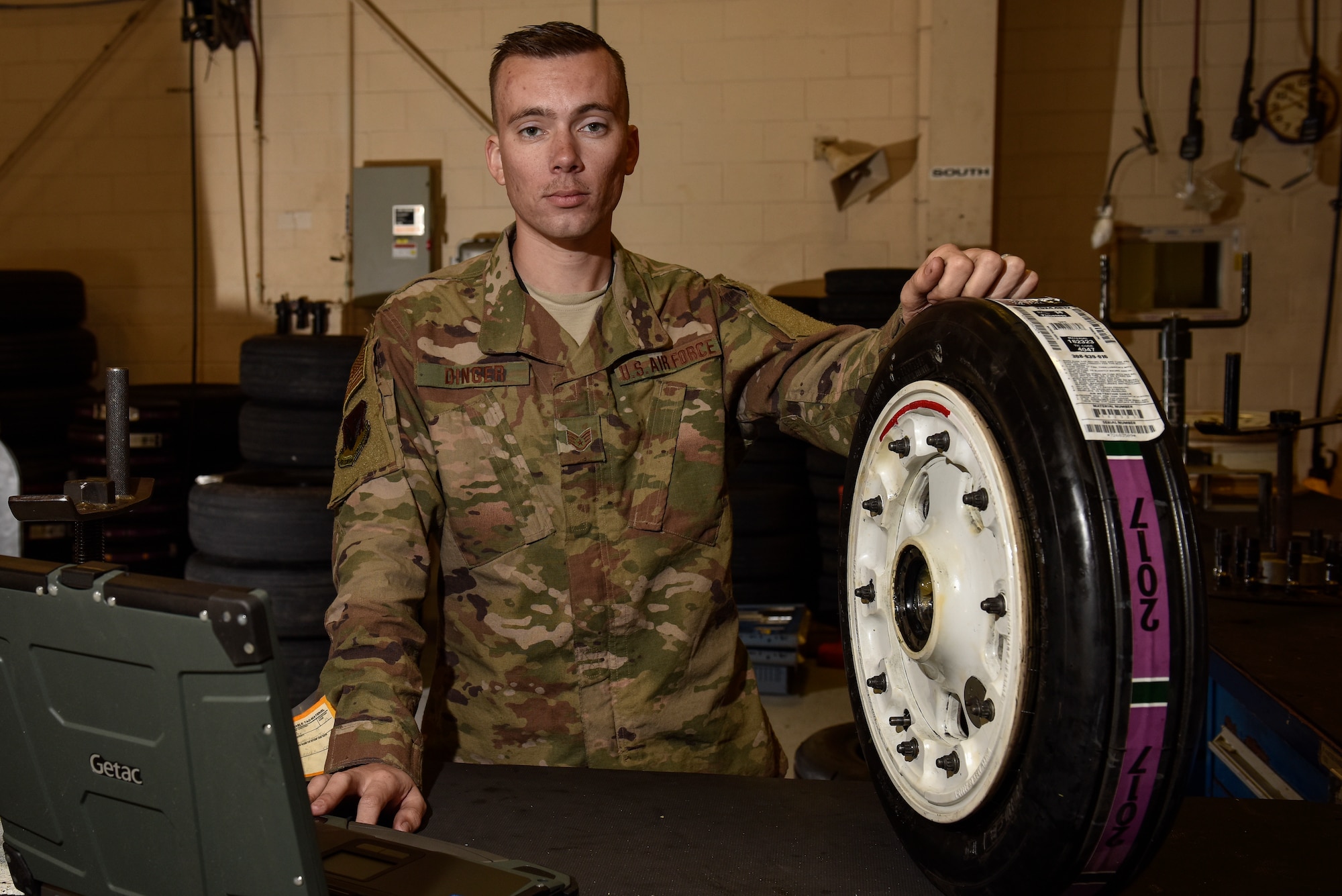 Staff Sgt. Kyle Dinger, 325th Aircraft Maintenance Squadron crew chief, poses for a portrait in the wheel and tire section at Tyndall Air Force Base, Fla. March 6, 2019.(U.S. Air Force photo by Staff Sgt. Alexandre Montes)