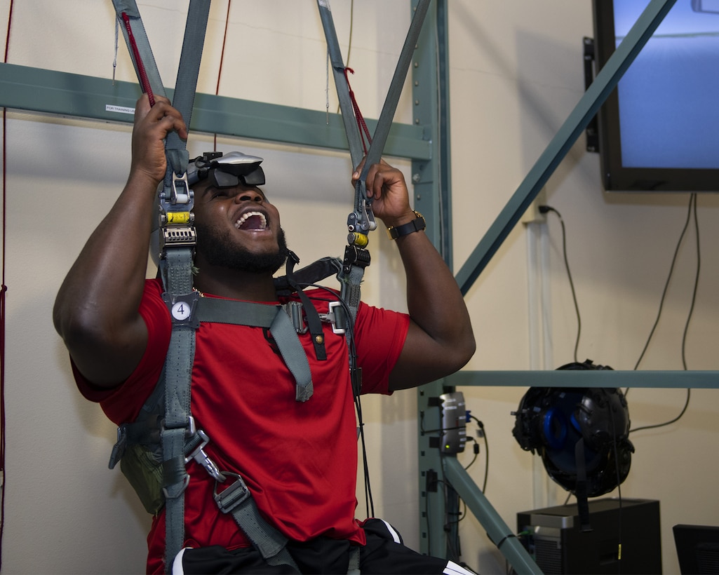 Grady Jarrett, Atlanta Falcons defensive tackle, experiences a parachute simulator at the Aircrew Flight Equipment facility Oct. 8, 2019, at Luke Air Force Base, Ariz.