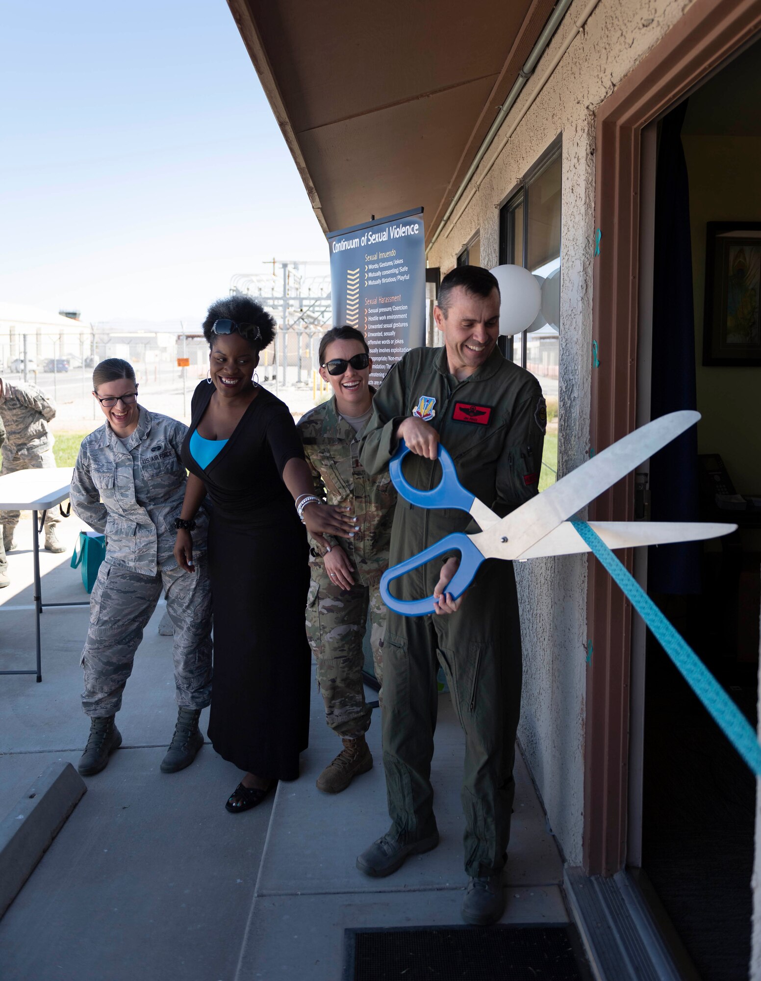 Col. James Price, 432nd Wing/432nd vice commander Air Expeditionary Wing, and SAPR personnel lead a ribbon-cutting ceremony at the new Sexual Assault Prevention and Response Office, at Creech Air Force Base, Nevada, Sept. 30, 2019. All of the same services provided at Nellis - victim advocates, referrals to mental health, counseling, medical care, special victims counsel and more are now available at Creech. (U.S. Air Force photo by Senior Airman Lauren Silverthorne)