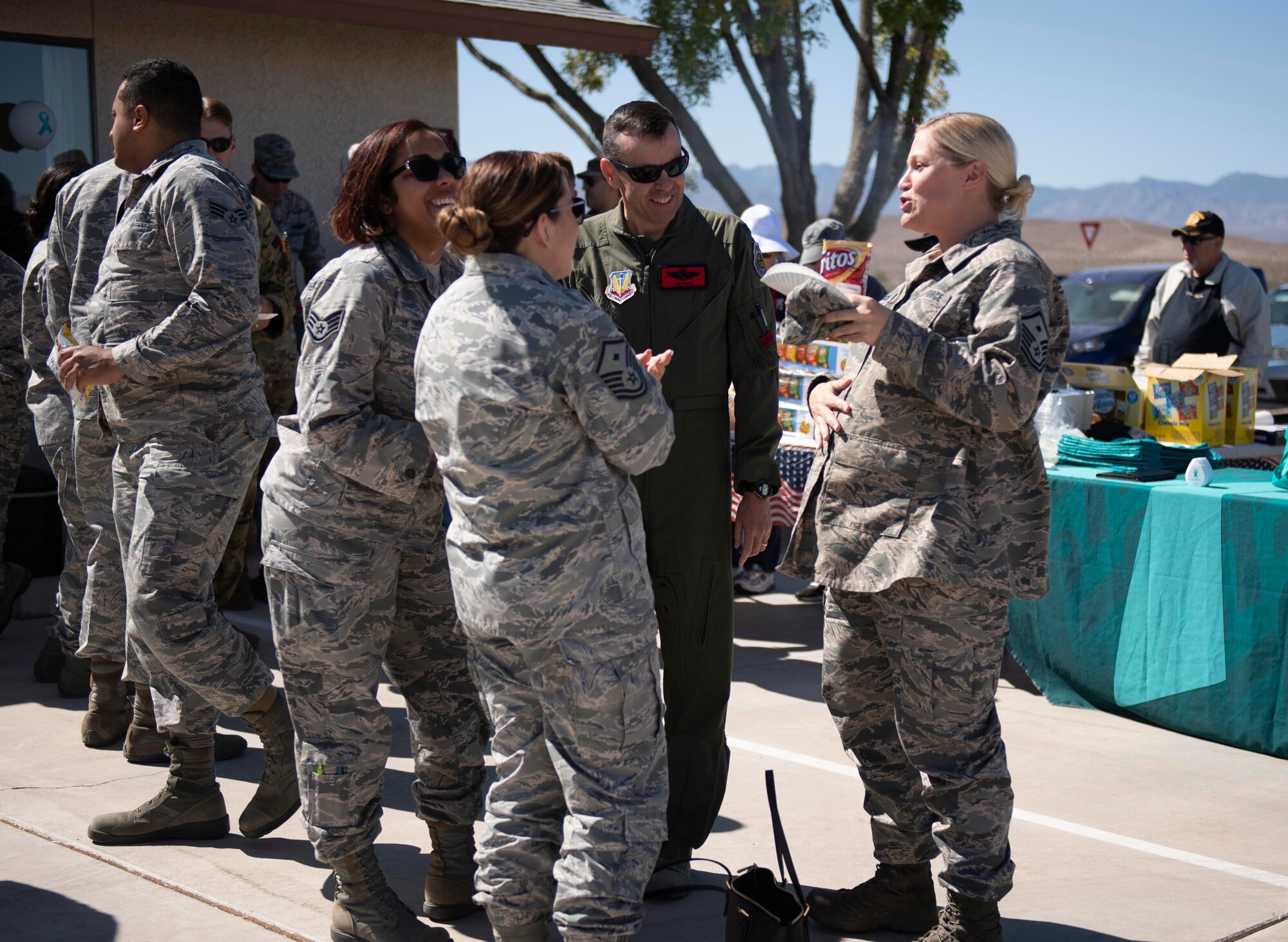 Personnel share lunch at the new Sexual Assault Prevention and Response Office opening at Creech Air Force Base, Nevada, Sept. 30, 2019. All of the same services provided at Nellis - victim advocates, referrals to mental health, counseling, medical care, special victims counsel and more are now available at Creech. (U.S. Air Force photo by Senior Airman Lauren Silverthorne)