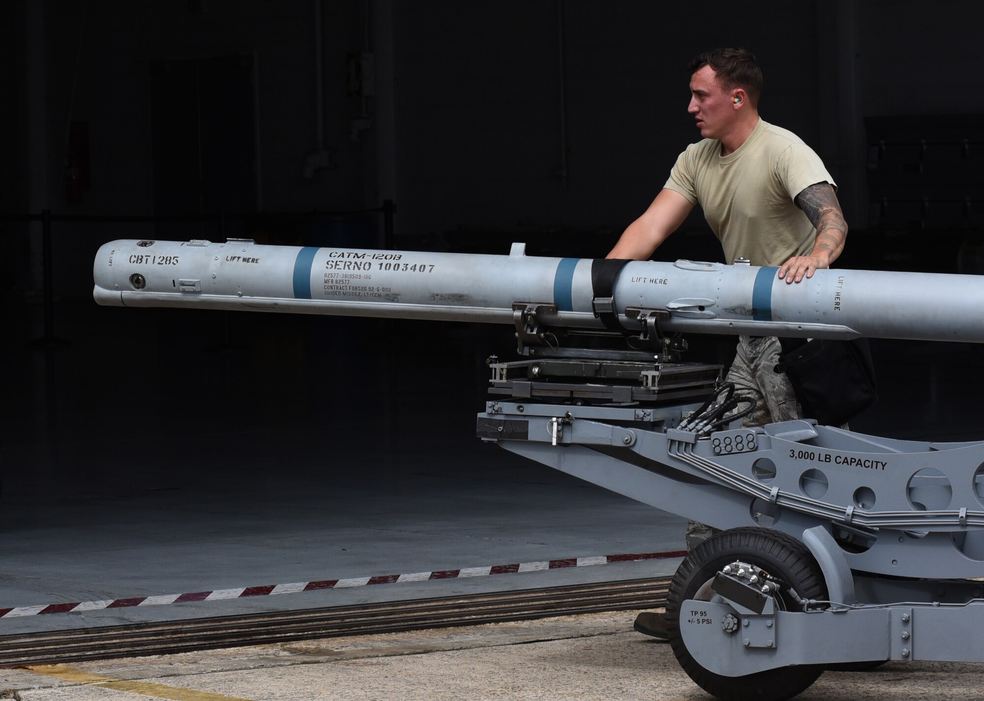 U.S. Air Force Staff Sgt. Christopher Whitten 79th Aircraft Maintenance Unit (AMU) load crew member helps guide munitions into the hanger during a quarterly load crew competition at Shaw Air Force Base, South Carolina, Oct. 7, 2019.