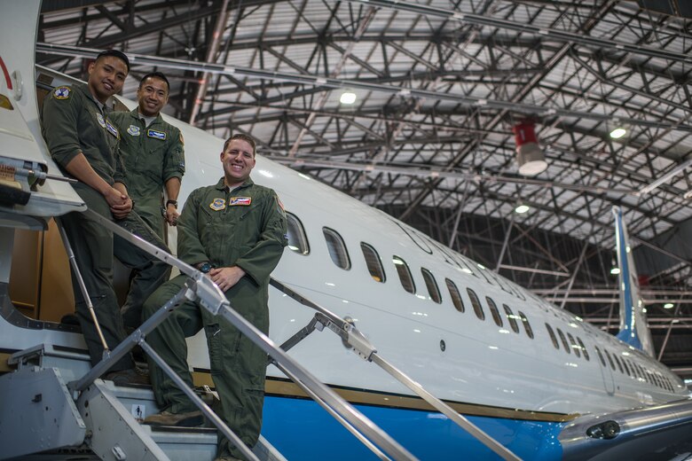 Crew from the 54th Airlift Squadron, pilots Maj. Neal Brinkworth, right, Maj. Andrew Floro, center, and executive flight attendant Senior Airman DJ Ramones, take a photo moment before giving tours of the 932nd Airlift Wing C-40 aircraft and sharing their Air Force careers with nearly 400 visiting JROTC high students from Missouri and Illinois, Oct. 8, 2019, Scott Air Force Base, Illinois. (U.S. Air Force photo by Christopher Parr)