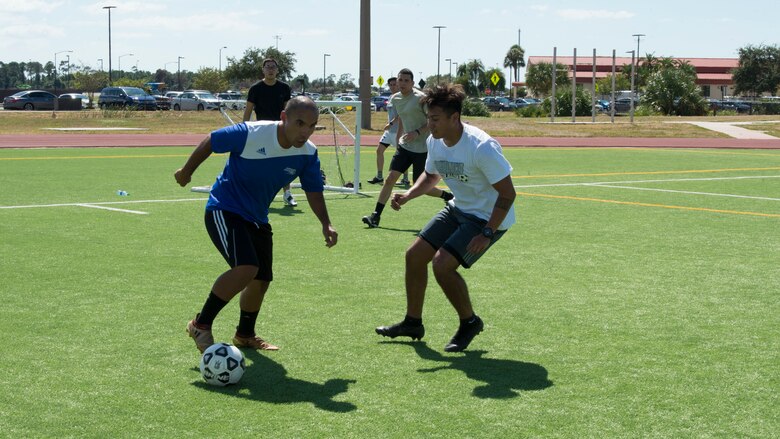 U.S. Air Force Tech. Sgt. Johann Bermudez, the 6th Health Care Operations Squadron family health NCO in charge, dribbles past a defender, during a match at MacDill’s Hispanic Heritage Soccer Tournament, Oct. 4, 2019, at MacDill Air Force Base, Fla. Over 50 participants played in the Hispanic Heritage Soccer Tournament, and awards were given to first, second, and third place teams. (U.S. Air Force photo by Airman 1st Class Shannon Bowman)