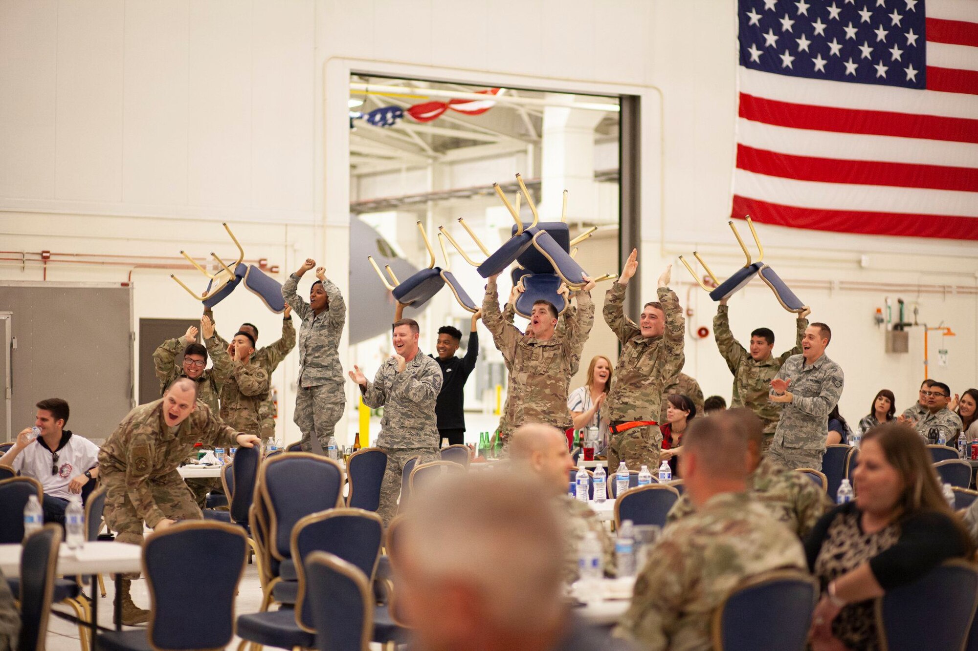 A group of maintainers from the 22nd Maintenance Squadron, celebrate as a fellow Airman receives an award during the Knucklebuster’s Award Ceremony Oct. 5, 2019, at McConnell Air Force Base, Kan. A total of 35 awards were given during the banquet.  (U.S. Air Force photo by 2nd Lt. Kaitlyn Danner)