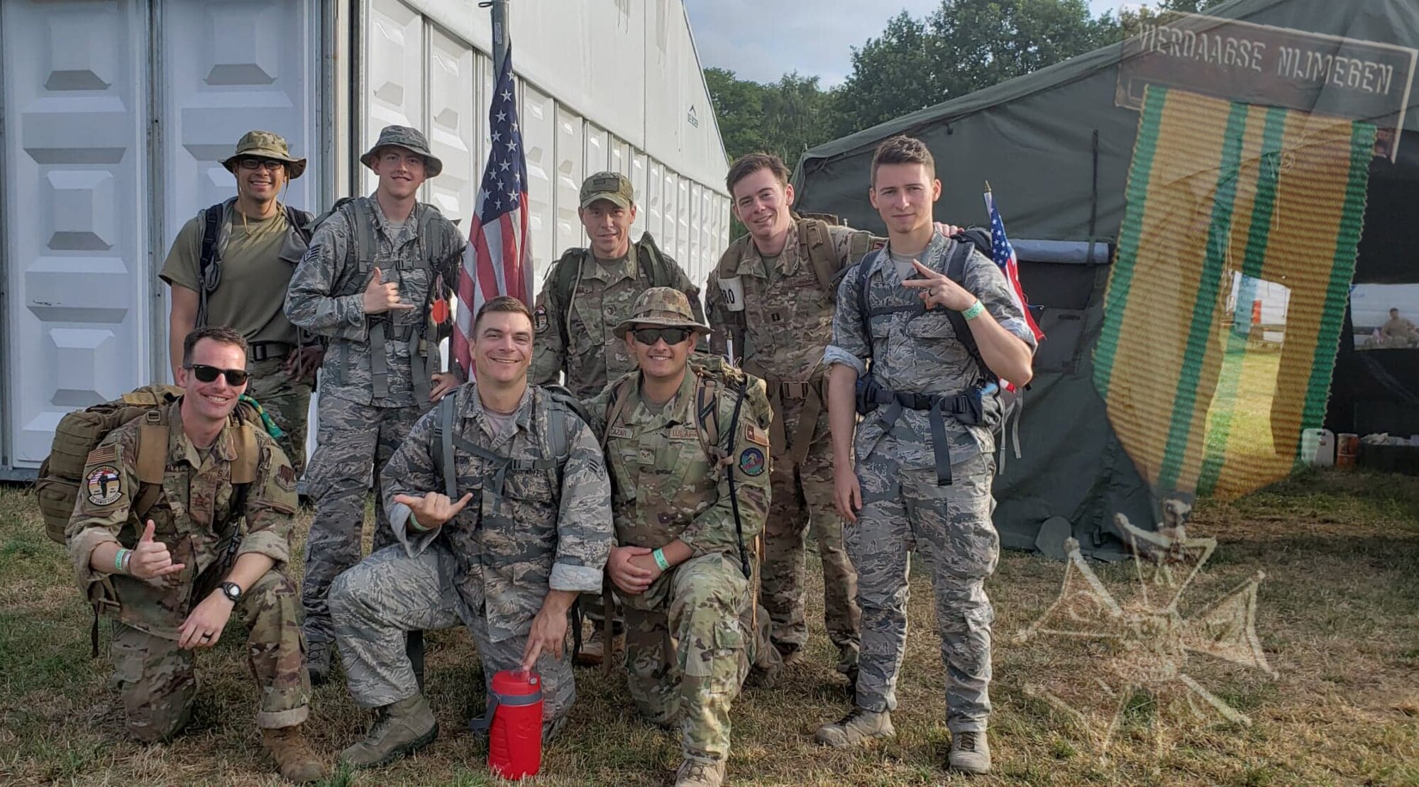 U.S. Air Force Airmen with the 693nd Intelligence, Surveillance and Reconnaissance Group at Ramstein Air Base, Germany, complete the Vierdaagse march in Nijmegen, Netherlands, July 16-19, 2019. Each of the eight Airmen carried 22 pounds for 100 miles over a 4-day period. The overlay is of the Vierdaagsekruis, or Four Days Cross medal, which was presented to participants by the Dutch government. (Courtesy photo illustration)