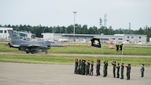 Members of the Japan Air Self-Defense Force waves at a 35th Fighter Wing F-16 Fighting Falcon pilot, during an aviation training relocation at Komatsu Air Base, Japan, Oct. 3, 2019. JASDF members remained on the flight line with squadron flags and smiles to say goodbye to each F-16 pilot prior to the conclusion and final sortie of the exercise. (U.S. Air Force photo by Senior Airman Collette Brooks)