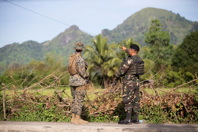 Philippine Air Force Airman Junnevee Cuenca points out a terrain feature to U.S. Marine Lance Cpl. Tatyana Saldana during KAMANDAG 3 at Colonel Ernesto P. Ravina Air Base, Philippines, Oct. 9, 2019. The specific objectives of KAMANDAG, such as mutual defense, counterterrorism, and humanitarian assistance and disaster relief, promote realistic training that supports regional security. Cuenca, a native of Zamboanga City, Philippines, is a combat air controller with 710th Special Operations Wing. Saldana, a native of Tallulah, La., is a military policeman with 3rd Law Enforcement Battalion. KAMANDAG 3 is a Philippine-led, bilateral exercise with participation from Japan. KAMANDAG is an acronym for the Filipino phrase “Kaagapay Ng Mga Manirigma Ng Dagat,” which translates to “Cooperation of the Warriors of the Sea,” highlighting the partnership between the U.S. and Philippine militaries.