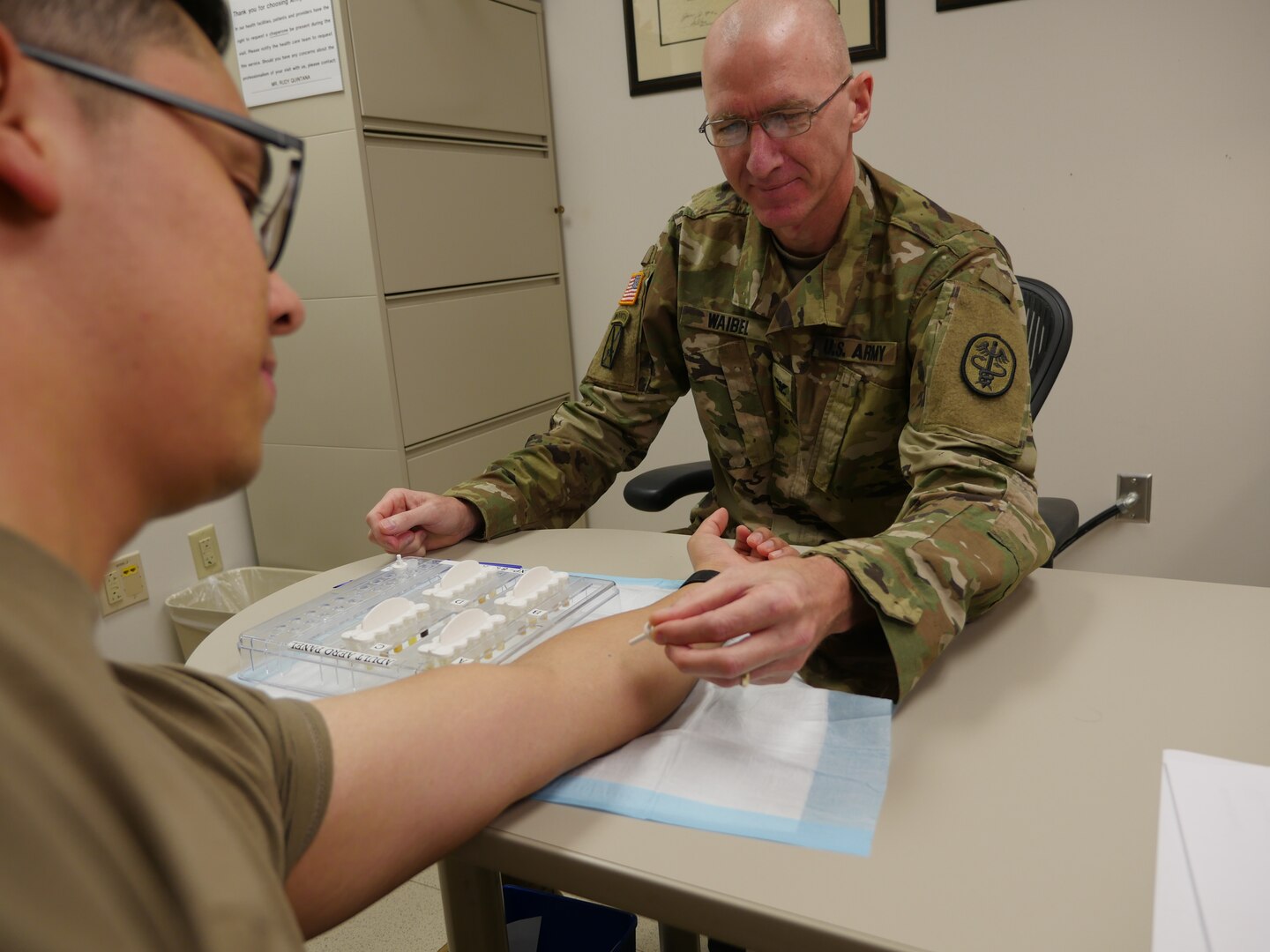 Army Col. (Dr.) Kirk Waibel, allergist/immunologist, prepares to give a mountain cedar allergy test to Army Sgt. Javier Pacheco in the Allergy/Immunology Clinic at Brooke Army Medical Center Oct. 8. Mountain cedar is one of the most common allergens in central and south Texas.