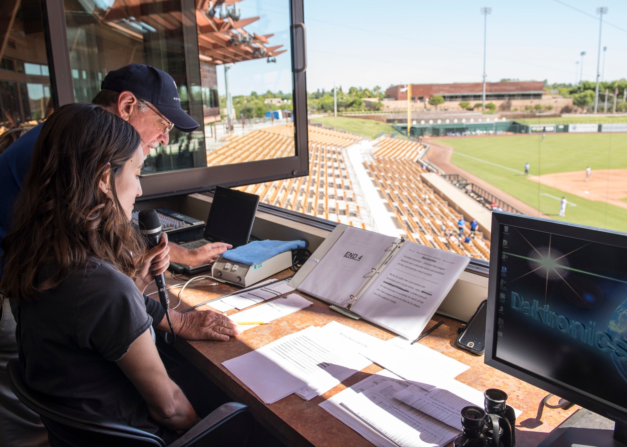 Airman 1st Class Leala Marquez, 56th Fighter Wing photojournalist, announces names of baseball players preparing to bat during a Major League Baseball Arizona Fall League military appreciation game Oct. 6, 2019, at Camelback Ranch stadium in Phoenix.