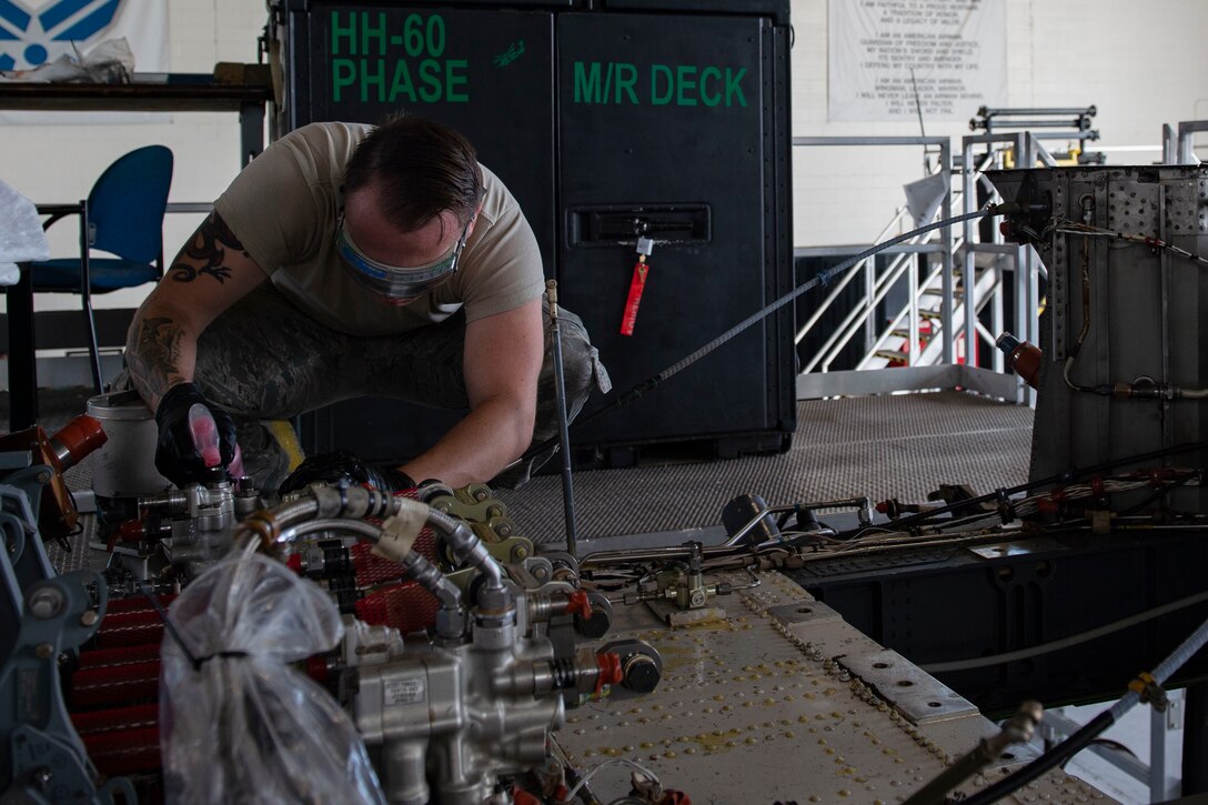 Airman 1st Class Zachary Paluch, 23d Maintenance Squadron (MXS) crew chief, sprays hydraulic fluid while changing pressure return lines during an HH-60G Pave Hawk phase inspection Oct. 9, 2019, at Moody Air Force Base, Ga. The 23d Maintenance Group maintainers disassemble, inspect and repair the HH-60 after every 600 flight hours. These maintainers continually work to ensure the aircraft are safe and reliable for search and rescue missions. (U.S. Air Force photo by Airman Azaria E. Foster)