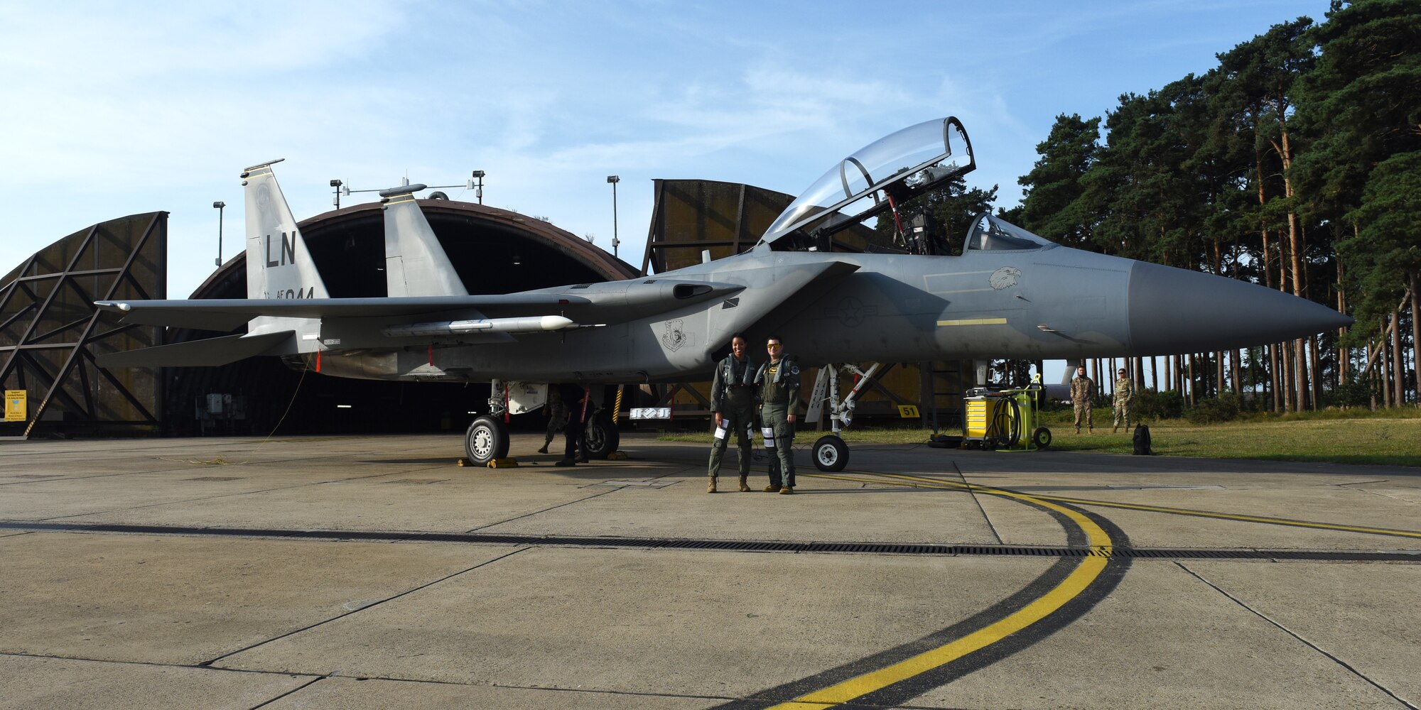 Captain Robert Volsey, 493rd Fighter Squadron pilot, and Senior Airman Danielle Jansen, 493rd Fighter Squadron intelligence analyst, pose for a photo before a familiarization flight at Royal Air Force Lakenheath, England, Aug. 21, 2019. Familiarization flights are authorized for individuals who normally have aviation-related responsibilities with aircraft and missions. (U.S. Air Force photo by Airman 1st Class Madeline Herzog)