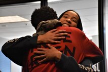 Marva Burns smiles as she hugs her son Marquis Butts after they both took the oath of enlistment, Oct. 8, Phoenix Military Entrance Processing Station. Both mother and son enlisted simultaneously in the U.S. Army. (U.S. Army Photo by Alun Thomas, Phoenix Recruiting Battalion Public Affairs)