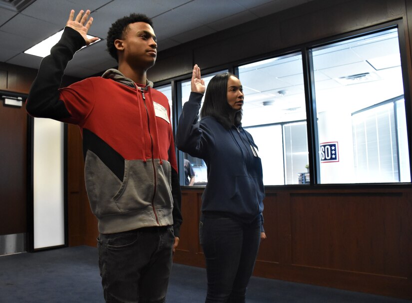 Marquis Butts (left) and his mother, Marva Burns (right), take the oath of enlistment, Oct. 8, Phoenix Military Entrance Processing Station. Both mother and son enlisted simultaneously in the U.S. Army. (U.S. Army Photo by Alun Thomas, Phoenix Recruiting Battalion Public Affairs)