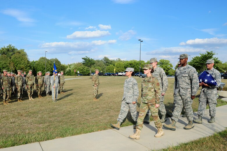 Members of the National Air and Space Intelligence Center, Global Exploitation Intelligence Group conduct a Retreat Ceremony on Oct. 1, 2019 at Wright-Patterson Air Force Base, Ohio. A Retreat Ceremony serves a twofold purpose. It signals the end of the official duty day and serves as a ceremony for paying respect to the flag.