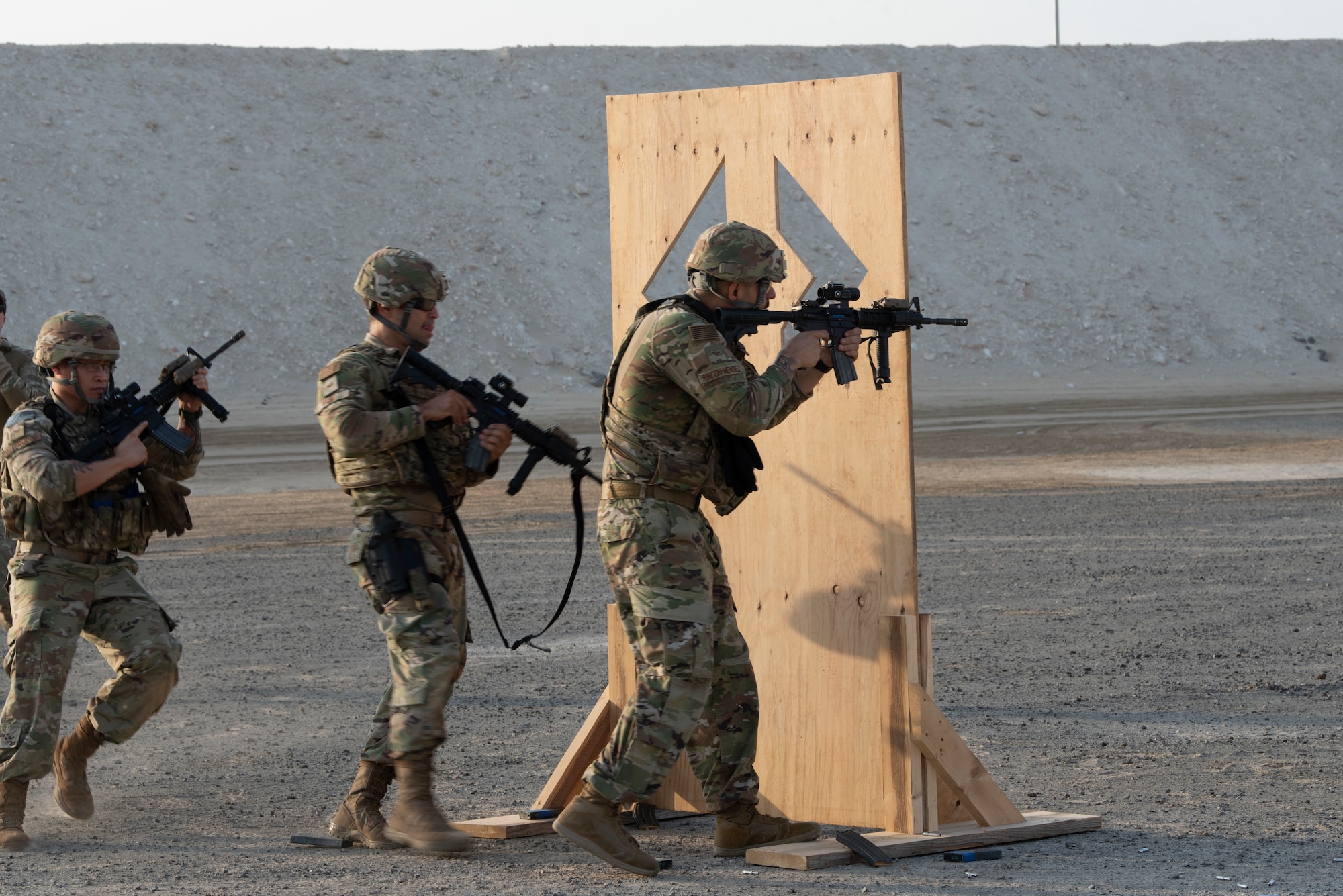 380th Expeditionary Security Forces Squadron Airmen fire from behind a barrier during a simunition proficiency firing course held on Al Dhafra Air Base, United Arab Emirates, Sept. 29, 2019.
