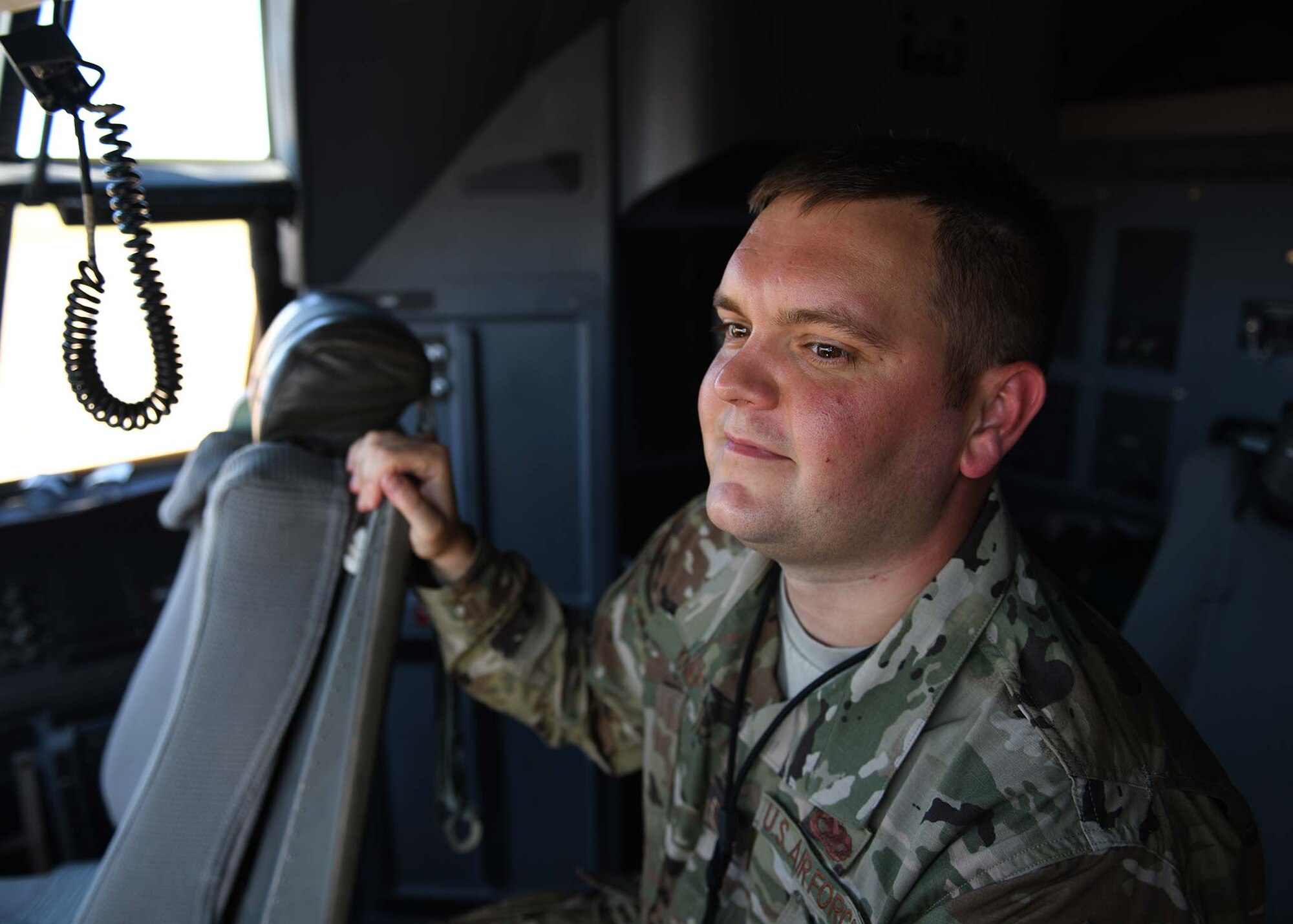 An Airman poses for a photo in a C-130