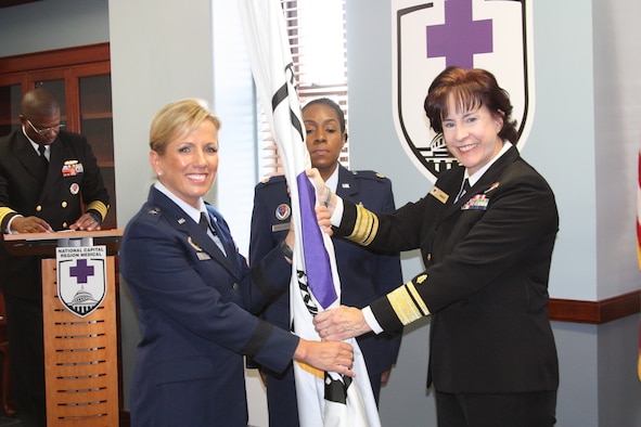 Brig. Gen. Shanna Woyak, Nevada Air National Guard, assumed authority of the National Capital Regional medical directorate from Rear Admiral Mary C. Riggs, left, during a ceremony at Walter Reed National Medical Center in Bethesda, Maryland, Oct. 9, 2019. Woyak, who served the past year as the Air National Guard advisor to the chief nurse of the U.S. Air Force, is the first Air National Guardsmen to lead the NCR medical directorate. (Photo by Bernard Little)