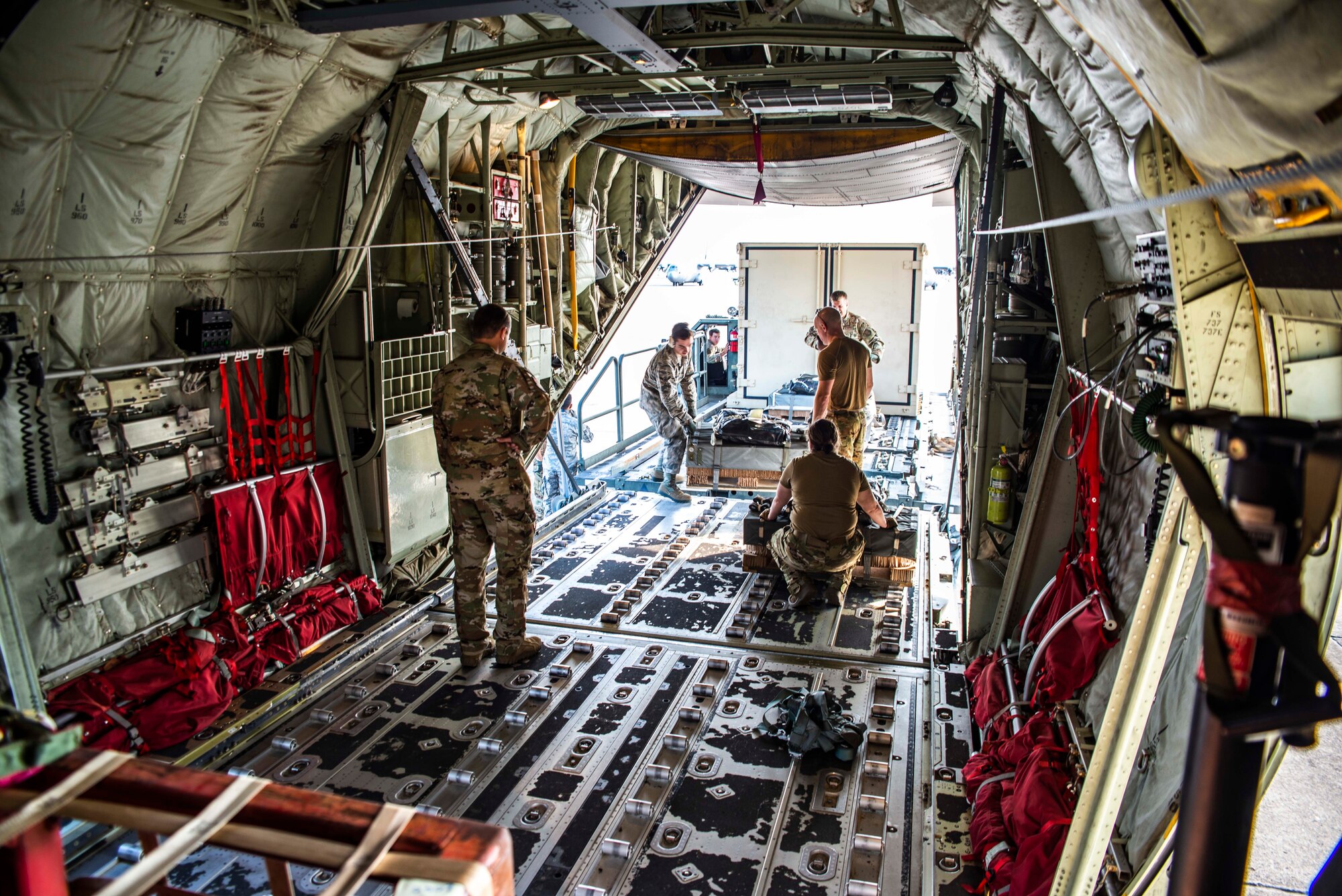 327th Airlift Squadron loadmasters assist in loading a C-130J Hercules before a low altitude training flight on October 5, 2019 at Little Rock Air Force Base, Ark. This training exercise provides aircrew the opportunity to experience multiple types of airdrops and drop zones while instilling tactical techniques and procedures for mobility operations. The robust and detailed training scenario allowed aircrew and air transportation specialists to operate in austere conditions, simulating enemies with an array of capabilities. (U.S. Air Force Reserve photo by Senior Airman Chase Cannon)