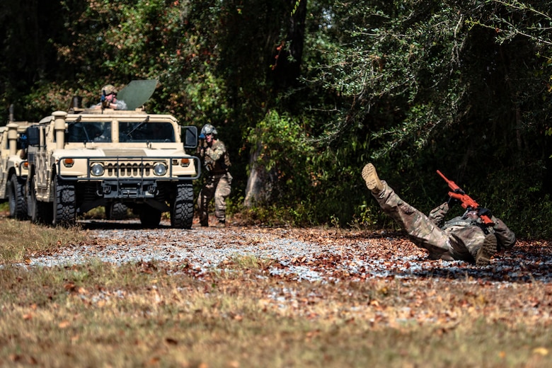 A simulated casualty, right, falls to the ground during a field convoy operation Oct. 8, 2019, at Moody Air Force Base, Ga. The field convoy operation gave 23d Security Forces Squadron Airmen an opportunity to improve the ability to shoot, move and communicate, ensuring the Airmen are properly trained and prepared to carry out their mission in a contested environment. (U.S. Air Force photo by Airman 1st Class Taryn Butler)