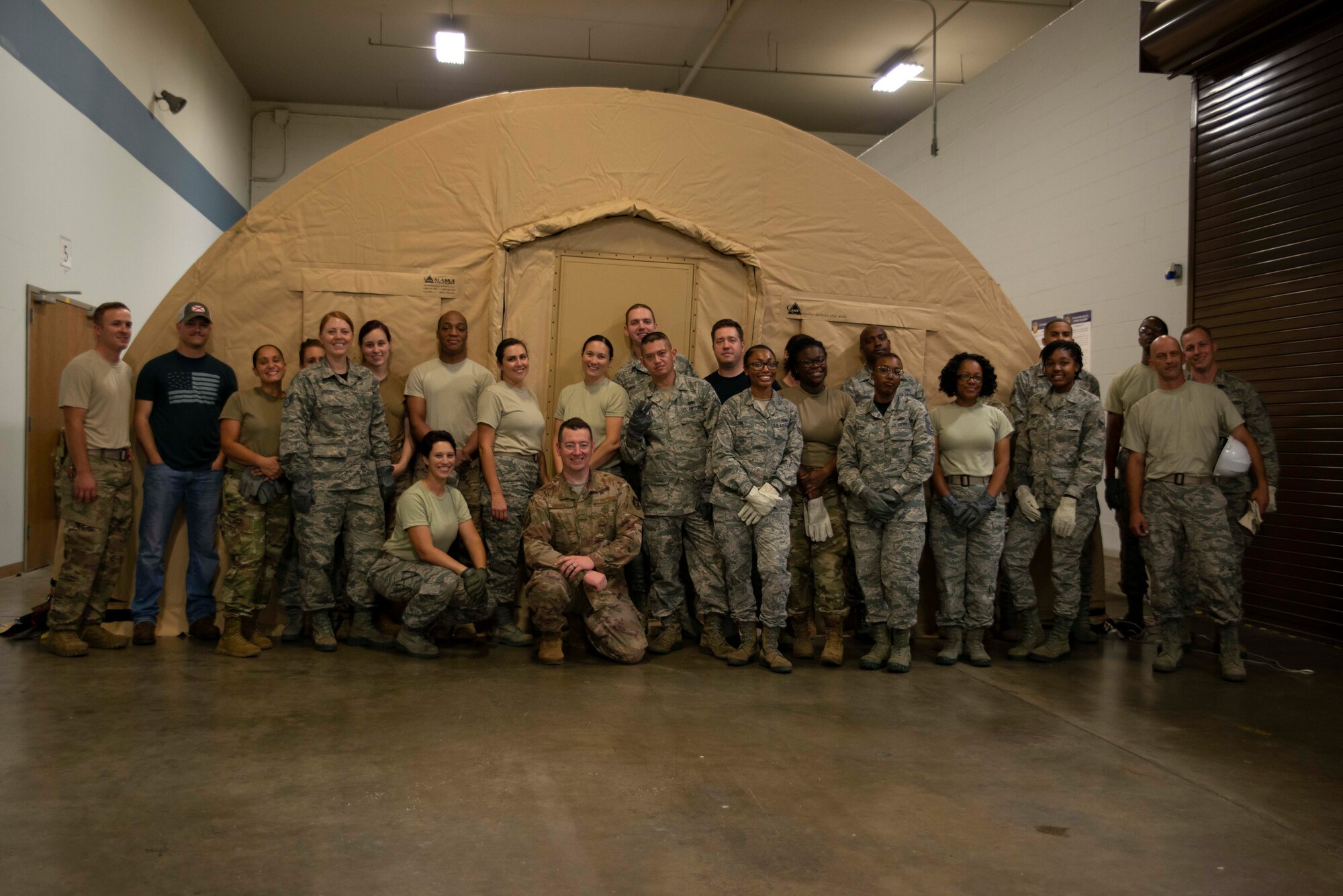 Members of the 913th Force Support Squadron pose for a group photo after completing tent build operations at Little Rock Air Force Base, Ark., Oct. 6, 2019. The ability to properly prepare and build a tent is essential for deployment or humanitarian environments. FSS provides the Air Force a range of services, from quality of life programs to combat support operations. (U.S. Air Force Reserve photo by Senior Airman Chase Cannon)