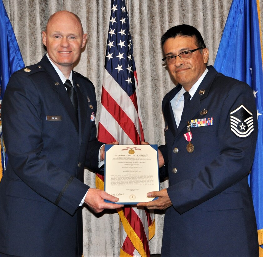 340th Flying Training Group Director of Personnel and Manpower Lt. Col. Mark Hiatt presents Master Sgt. Robert Sanchez, 340th Flying Training Group education and training chief, with the Meritorious Service Medal certificate during Sanchez's Sept. 13 retirement ceremony at Joint Base San Antonio-Randolph, Texas. (U.S. Air Force photo by Janis El Shabazz)