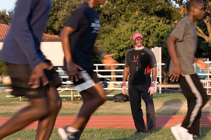 Tony Lightner watches his trainees during track and field practice Oct. 2 at JBSA Randolph. Lightner, despite health hurdles, has trained kids in track and field for free since 2006