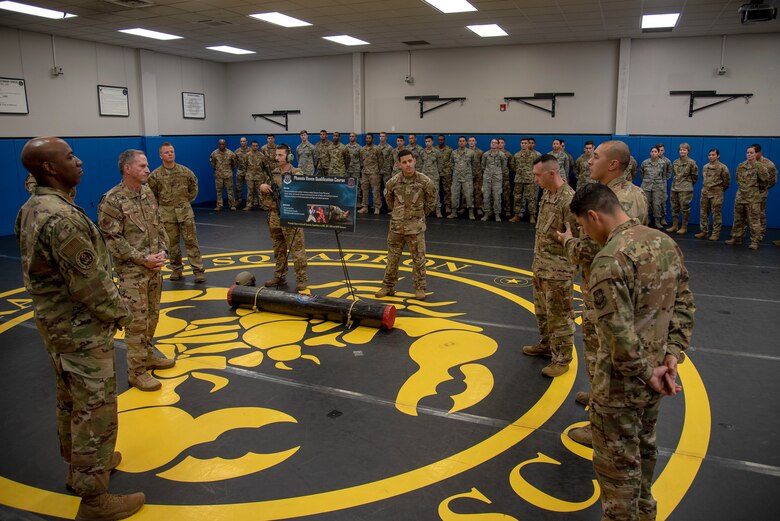 U.S. Air Force Tech. Sgt. Marcus Collaso, Phoenix Raven Qualification Course instructor assigned to the 421st Combat Training Squadron, explains how students are taught to get compliance from an adversary to Air Force Chief of Staff Gen. David L. Goldfein and Chief Master Sgt. of the Air Force Kaleth O. Wright during their visit to the U.S. Air Force Expeditionary Center as part of 2019 Fall Phoenix Rally, Oct. 9, 2019, at Joint Base McGuire-Dix-Lakehurst, New Jersey.  Fall Phoenix Rally is a three-day summit focused on understanding leadership roles in emerging issues with Air Mobility Command, bringing together leadership and spouses from throughout the command.