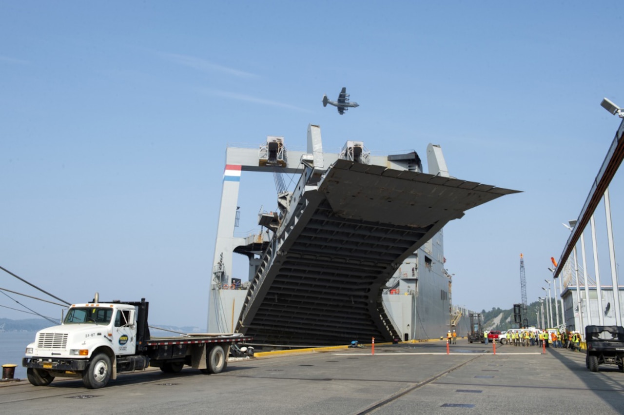 Army vehicles, equipment unloaded in Alaska.