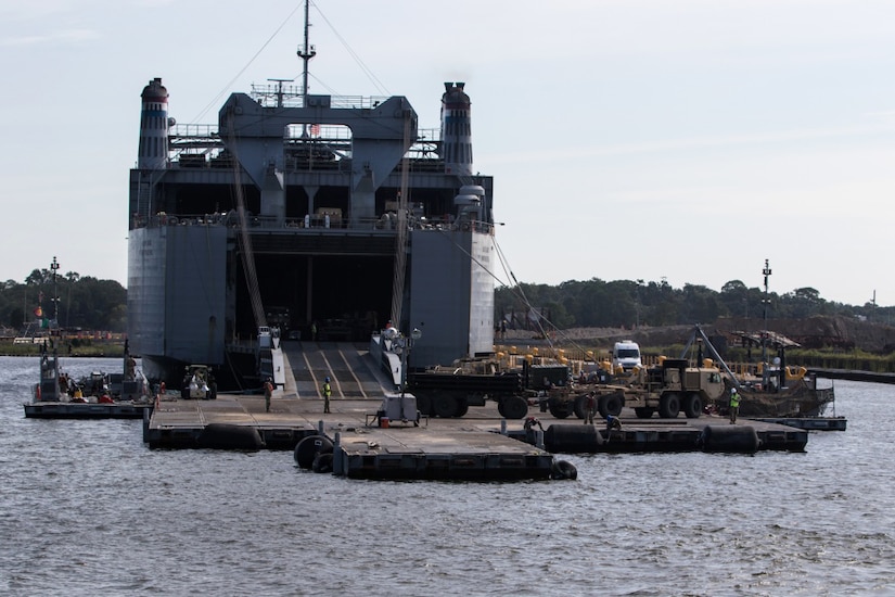 Soldiers unload equipment during exercise.