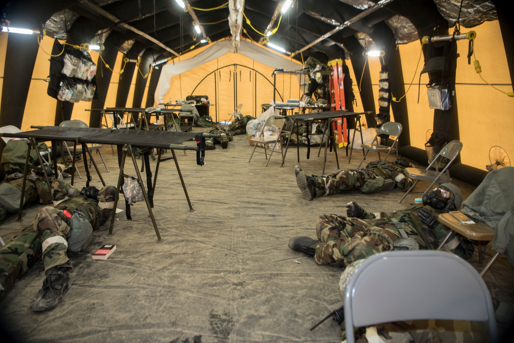 U.S. Airmen, assigned to the 673d Air Base Wing, take shelter inside a tent in mission-oriented protective posture level 4, in a simulated hazardous environment during a training and readiness exercise, Polar Force 20-1, at Joint Base Elmendorf-Richardson, Alaska, Oct. 9, 2019. Designed to test JBER’s mission readiness, Polar Force 20-1 is a two-week exercise that hones Airmen’s skills and experience when facing adverse situations. Airmen refined their contingency tactics, techniques and procedures in support of the Pacific Air Force’s Agile Combat Employment concept of operations. Agile Combat Support excellence yields multi-domain operations success.