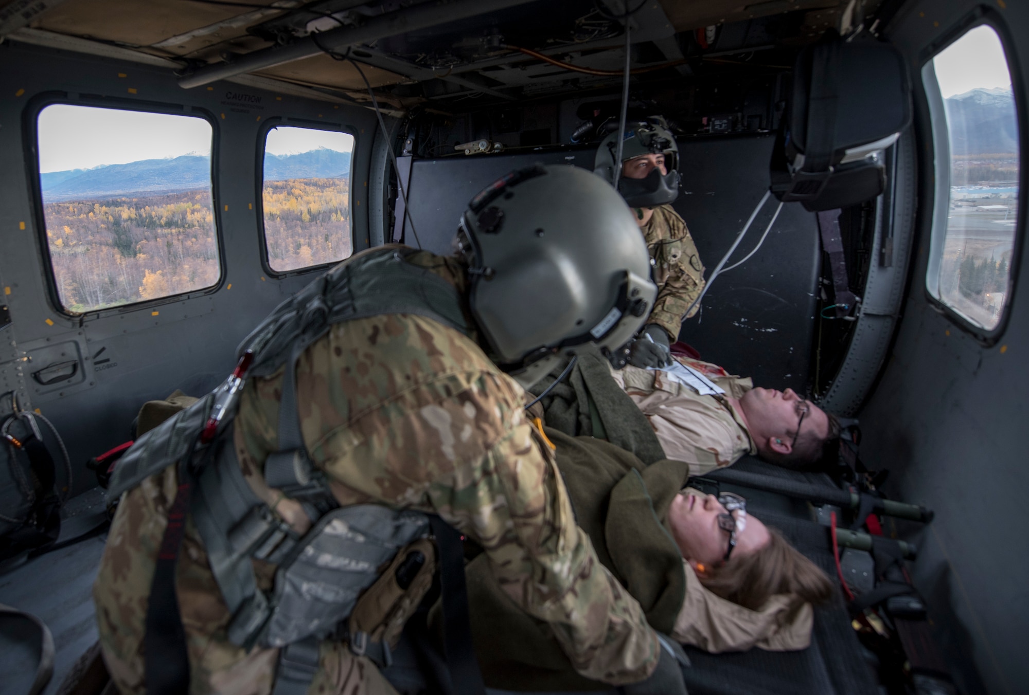 U.S. Army staff sergeants Mikana Halloran and Damion Minchaca, 2-104th G Company, 2nd Battalion, 2nd Detachment, Air Ambulance, Alaska Army National Guard flight paramedics, attend simulated wounds of patients during a training and readiness exercise, Polar Force 20-1, at Joint Base Elmendorf-Richardson, Alaska, Oct. 8, 2019. Designed to test JBER’s mission readiness, Polar Force 20-1 is a two-week exercise that hones Airmen’s skills and experience when facing adverse situations. Airmen refined their contingency tactics, techniques and procedures in support of the Pacific Air Force’s Agile Combat Employment concept of operations. Agile Combat Support excellence yields multi-domain operations success.