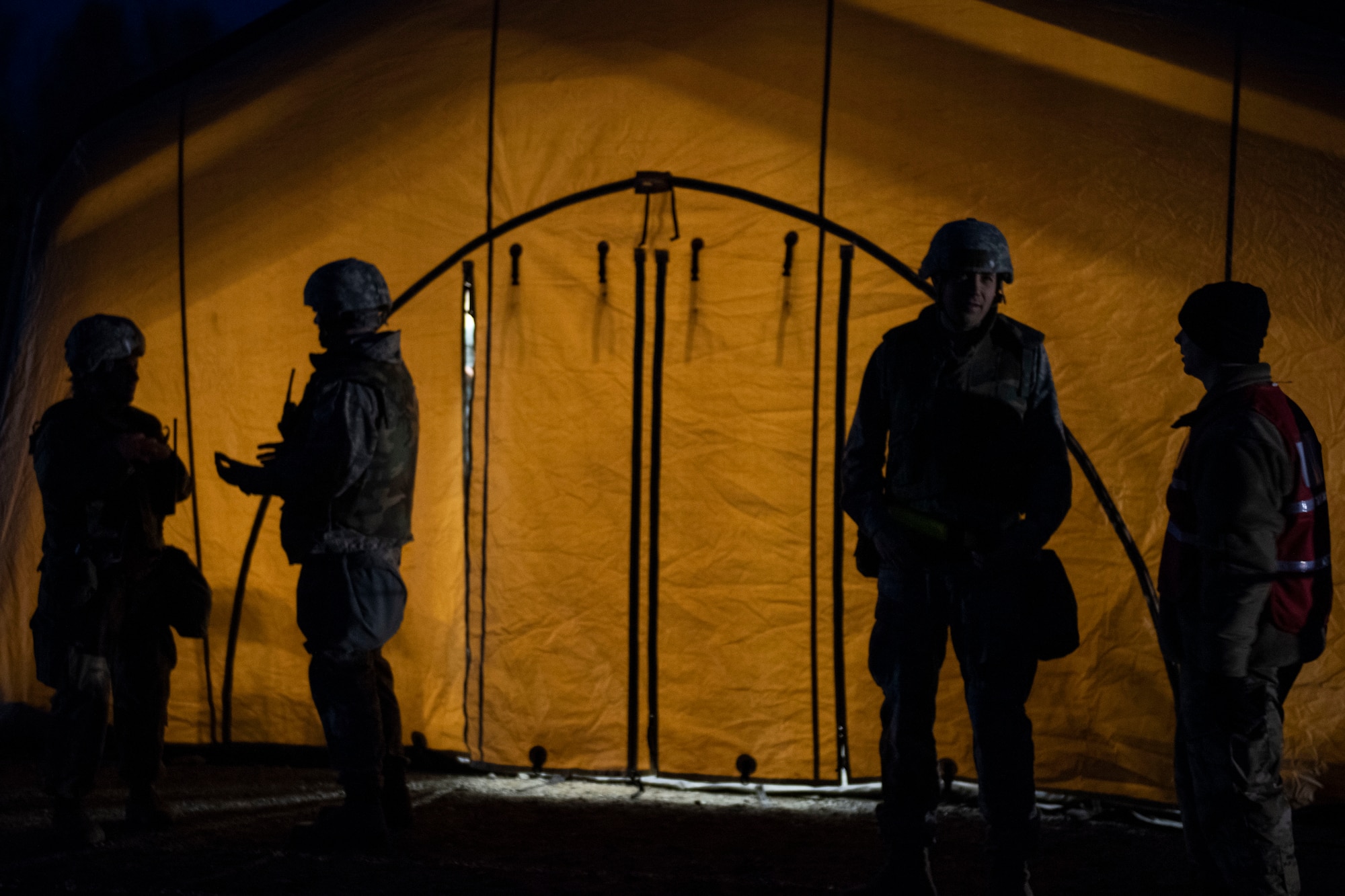 U.S. Airmen assigned to Joint Base Elmendorf-Richardson talk outside an Expeditionary Medical Support System tent during Polar Force 20-1 at JBER, Alaska, Oct. 8, 2019. Designed to test JBER’s mission readiness, Polar Force 20-1 is a two-week exercise that hones Airmen’s skills and experience when facing adverse situations. Airmen refined their contingency tactics, techniques and procedures in support of the Pacific Air Force’s Agile Combat Employment concept of operations. Agile Combat Support excellence yields multi-domain operations success.