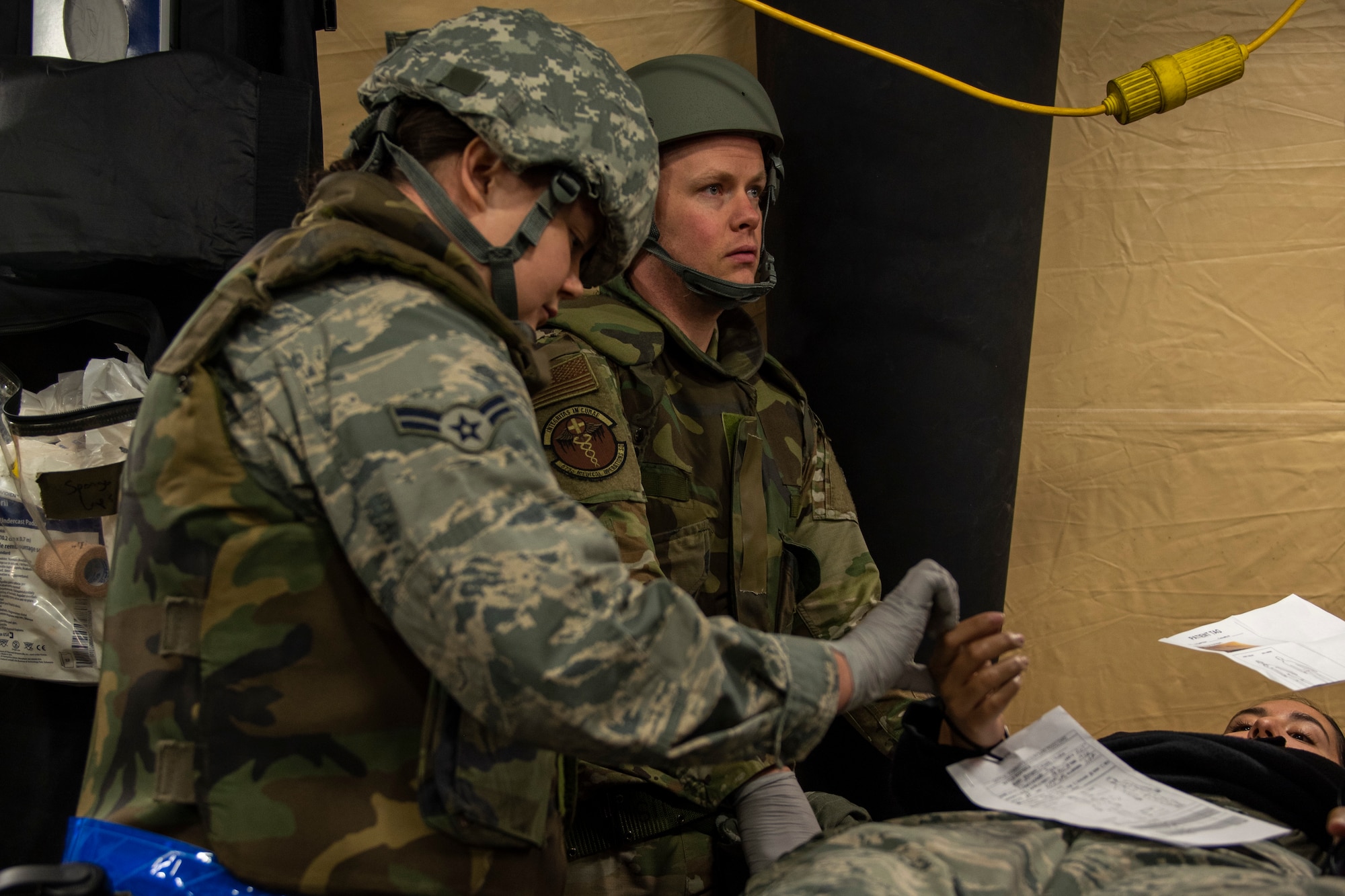 U.S. Airmen assigned to the 673d Medical Group provide Tactical Combat Casualty Care to an Airman with simulated injuries in an Expeditionary Medical Support System tent during Polar Force 20-1 at Joint Base Elmendorf-Richardson, Alaska, Oct. 8, 2019. Designed to test JBER’s mission readiness, Polar Force 20-1 is a two-week exercise that hones Airmen’s skills and experience when facing adverse situations. Airmen refined their contingency tactics, techniques and procedures in support of the Pacific Air Force’s Agile Combat Employment concept of operations. Agile Combat Support excellence yields multi-domain operations success.