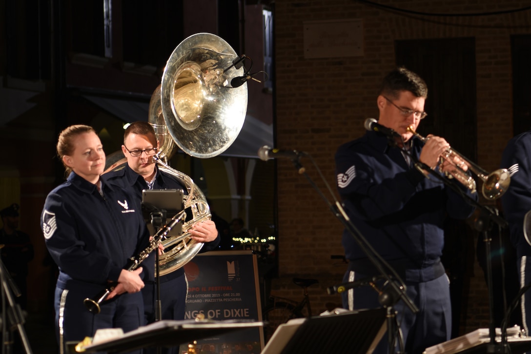 U. S. Air Force Staff Sgt. Jimmy Hubbard (right), Wings of Dixie music director, plays a trombone solo during a U.S. Air Forces in Europe and Air Forces Africa band performance in Portogruaro, Italy, Oct. 4, 2019. The Wings of Dixie ensemble plays a broad range of music from World War I era to today’s top rock and roll and pop hits. (U.S. Air Force photo by Julie Scott)