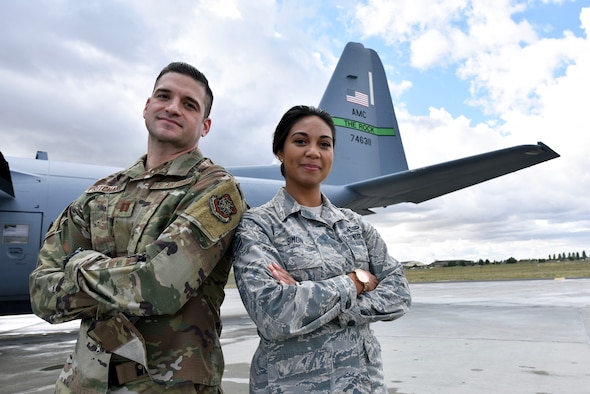Airmen pose for a photo in front of a C-130.
