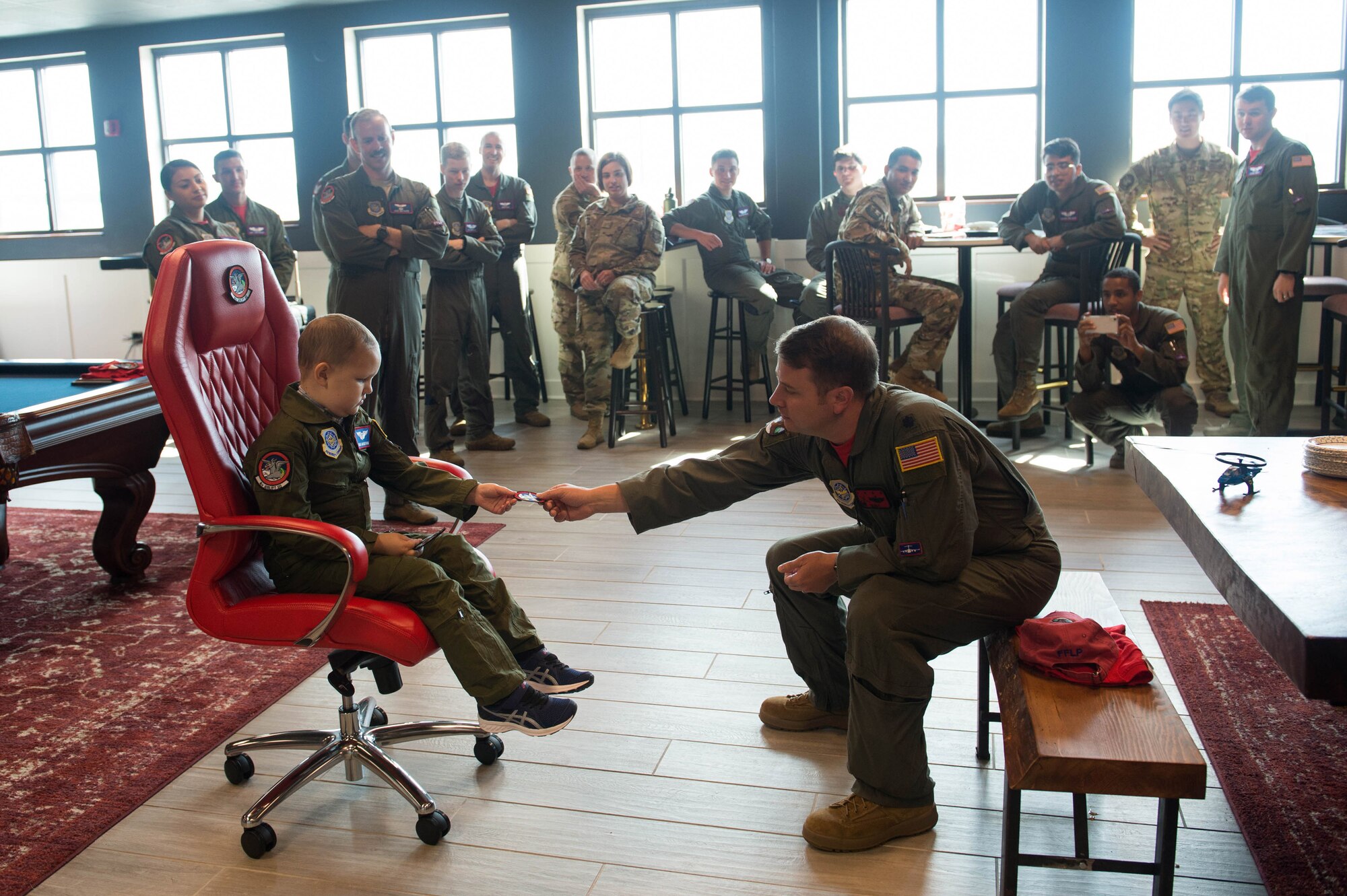 Lt. Colonel Sean Burke, 4th Airlift Squadron commander, gives Noah Markstrom, Team McChord’s newest pilot for a day, a squadron sticker at Joint Base Lewis-McChord, Wash., Sept. 6, 2019. The Pilot for a Day program lets kids with disabilities or illnesses take part in some of Team McChord’s missions.