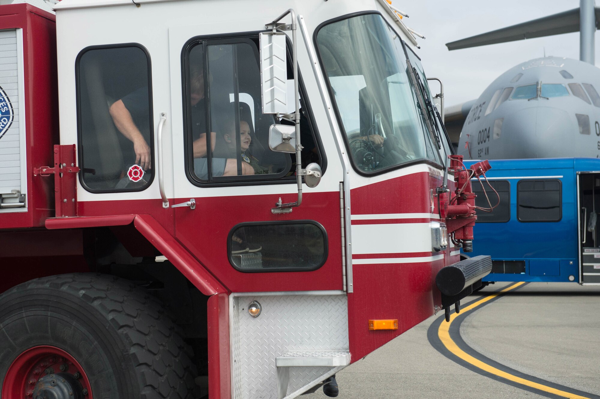 Noah Markstrom, Team McChord’s newest pilot for a day, rides in a fire truck at Joint Base Lewis-McChord, Wash., Sept. 6, 2019. Along with the fire truck ride, the day included a tour of a C-17 Globemaster III and a chance to get behind the C-17 controls and fly a mission in the simulator building.