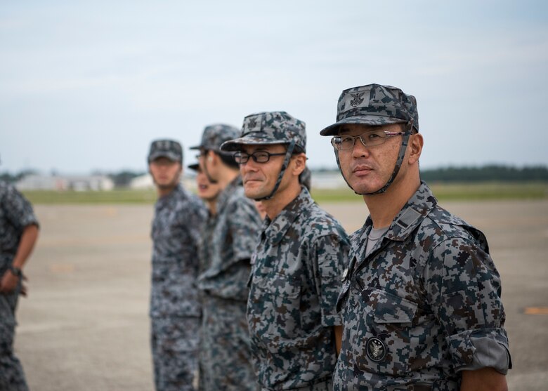 Japan Air Self-Defense Force members stand on the flight prior to an F-16 Fighting Falcon training demonstration during an aviation training relocation at Komatsu Air Base, Japan, Oct. 2, 2019. The week-long exercise included within visual range air-to-air combat, bilateral aircraft recovery, refueling, launching and joint usage and training of aerospace ground equipment. These F-16s assigned to the 35th Fighter Wing relocated from Misawa AB to Komatsu AB for a week-long bilateral training. (U.S. Air Force photo by Senior Airman Collette Brooks)