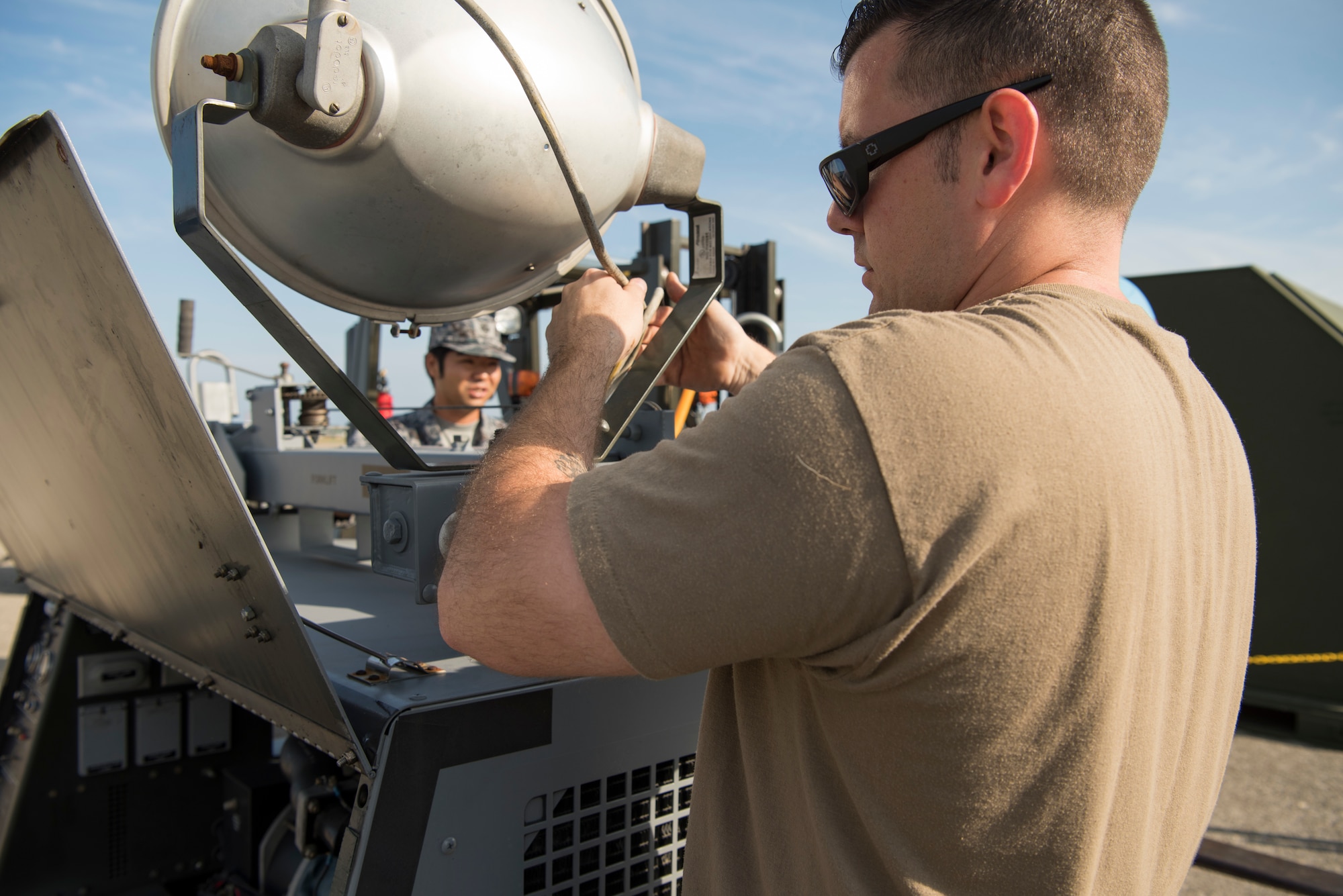 U.S. Air Force Tech. Sgt. Jesse Reddam, the 35th Maintenance Squadron aerospace ground equipment inspection and repair section chief, sets up AGE equipment during an aviation training relocation at Komatsu Air Base, Japan, Oct. 1, 2019. The week-long exercise included within visual range air-to-air combat, bilateral aircraft recovery, refueling, launching and joint usage and training of AGE equipment. (U.S. Air Force photo by Senior Airman Collette Brooks)
