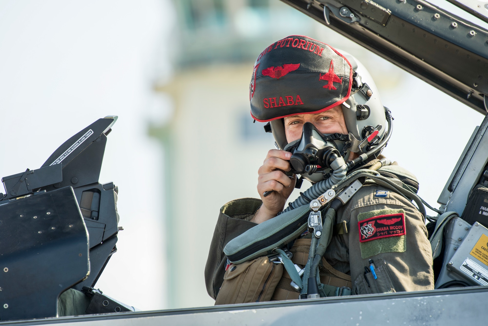 U.S. Air Force Capt. Phillip McCoy, a 13th Fighter Squadron F-16 Fighting Falcon pilot, dons his face mask before flight during an aviation training relocation at Komatsu Air Base, Japan, Oct. 1, 2019. Pilots conducted within visual range air-to-air combat training with Japan Air Self- Defense Force pilots aiding in the increase of tactical strength, friendship and alliance. (U.S. Air Force photo by Senior Airman Collette Brooks)