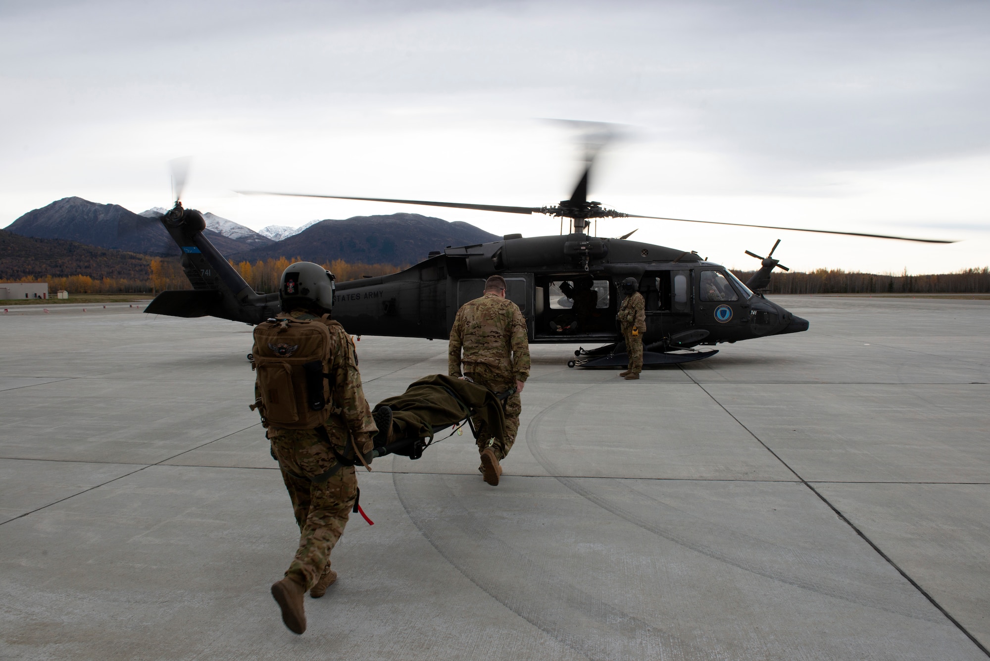 U.S. Army Staff Sgt. Mikana Halloran, flight medic, and U.S. Army Maj. Titus Rund, flight surgeon, both with the 2-104th G. Company, 2nd Battalion, 2nd Detachment, Air Ambulance, Alaska Army National Guard, load an Airman with a simulated injury into an AKARNG UH-60L Black Hawk for a medical evacuation during Polar Force 20-1 at Joint Base Elmendorf-Richardson, Alaska, Oct. 8, 2019. Designed to test JBER’s mission readiness, Polar Force 20-1 is a two-week exercise that hones Airmen’s skills and experience when facing adverse situations. Airmen refined their contingency tactics, techniques and procedures in support of the Pacific Air Force’s Agile Combat Employment concept of operations. Agile Combat Support excellence yields multi-domain operations success.
