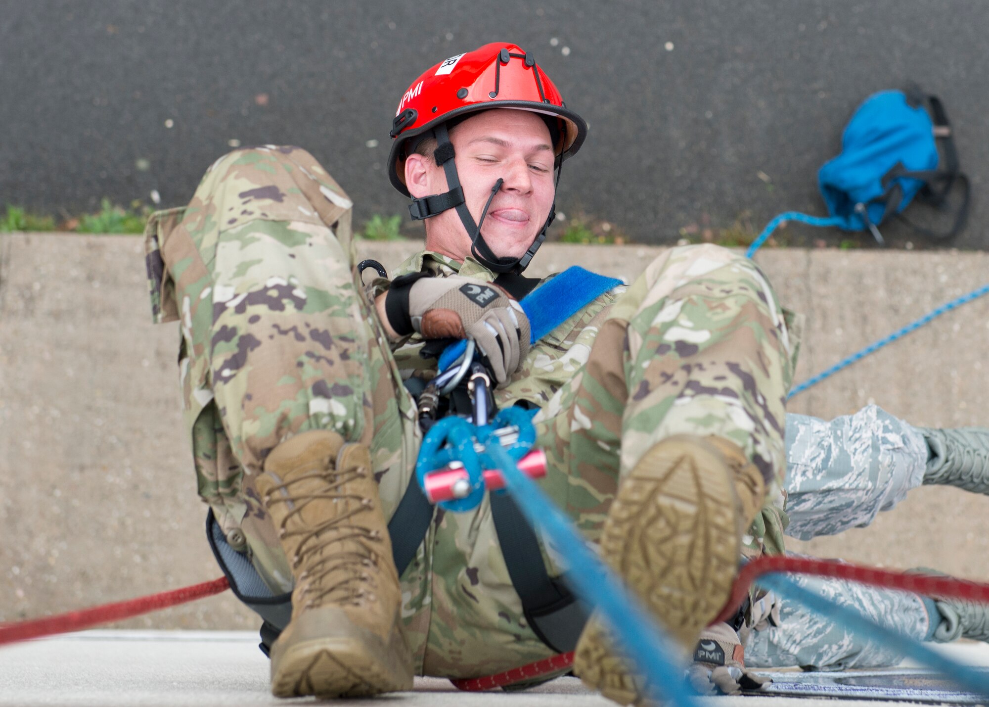 U.S. Air Force Staff Sgt. Robert Wellborn, 435th Construction and Training Squadron fire rescue and contingency training instructor, demonstrates a suspended victim rescue during a Rescue Technician I Course at the 435th CTS compound near Ramstein Air Base, Germany, Oct. 10, 2019. To safely rescue suspended victims, firefighters might have to hang themselves upside down to fasten their belts to the victim and pull them both to safety.