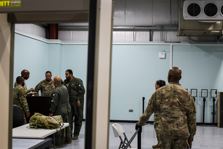 U.S. Air Force service members give a tour of their work area to Kuwaiti air force members at Ahmed Al Jaber Air Base, Kuwait, Sept. 25, 2019. Both militaries participated in a subject matter expert exchange on cargo transportation and preparation, learning about each other’s processes and providing feedback. (U.S. Air Force photo by Senior Airman Lane T. Plummer)