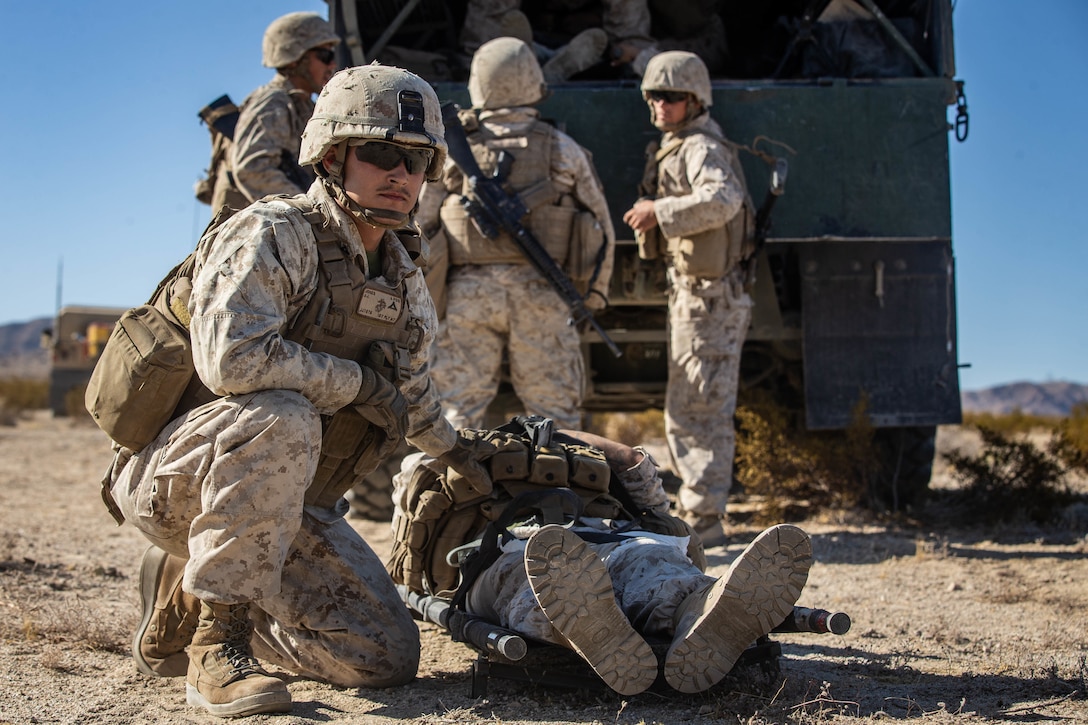 U.S. Marine Corps Lance Cpl. Jakob Jones with Combat Logistics Battalion 8, Combat Logistics Regiment 2, 2nd Marine Logistics Group, kneels next to a simulated casualty during motorized operations course as part Integrated Training Exercise1-20 on Marine Corps Air Ground Combat Center Twentynine Palms, California, Oct. 5, 2019. CLB-8 integrated with 2nd Marine Regiment during ITX to provide direct support and tactical logistics beyond the regiment's organic capabilities in the areas of transportation, field level maintenance, and general engineering.
