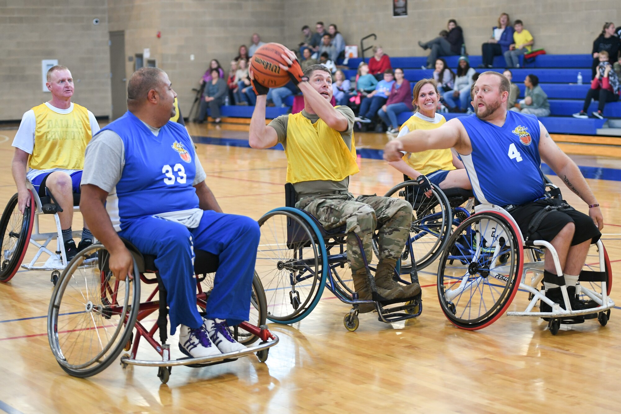 Major Michael Twining, 75th Security Forces Squadron commander, shoots the ball during a wheelchair basketball game Oct. 9, 2019 at Hill Air Force Base, Utah. Leaders from Hill's units faced off against the Ogden Wheelin' Wildcats, a semi-professional wheelchair basketball team, to celebrate National Disability Employment Awareness Month. (U.S. Air Force photo by Cynthia Griggs)