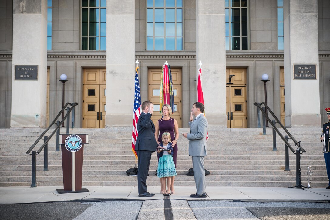 Defense Secretary Dr. Mark T. Esper and Army Secretary Ryan D. McCarthy face each other outside the Pentagon.