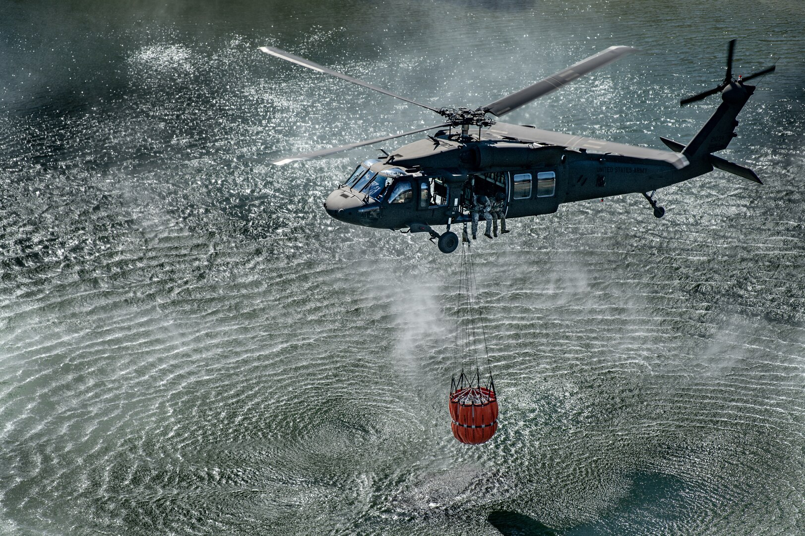 Members of the West Virginia Army National Guard's (WVARNG) Company C, 1st Battalion, 150th Aviation Regiment completed Bambi Bucket training for three aircrews consisting of 12 Soldiers at Camp Dawson, West Virginia, Oct. 10, 2019. This type of familiarization training ensures that aircrew members can successfully link up with civilian firefighting agencies to provide response to wildfire incidents in the State of West Virginia. (U.S. National Guard photo by Edwin Wriston)