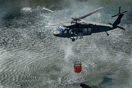 Members of the West Virginia Army National Guard's (WVARNG) Company C, 1st Battalion, 150th Aviation Regiment completed Bambi Bucket training for three aircrews consisting of 12 Soldiers at Camp Dawson, West Virginia, Oct. 10, 2019. This type of familiarization training ensures that aircrew members can successfully link up with civilian firefighting agencies to provide response to wildfire incidents in the State of West Virginia. (U.S. National Guard photo by Edwin Wriston)