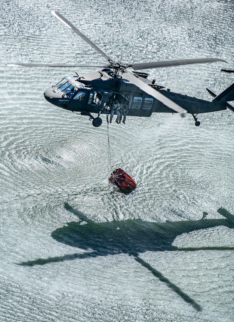 Members of the West Virginia Army National Guard's (WVARNG) Company C, 1st Battalion, 150th Aviation Regiment completed Bambi Bucket training for three aircrews consisting of 12 Soldiers at Camp Dawson, West Virginia, Oct. 10, 2019. This type of familiarization training ensures that aircrew members can successfully link up with civilian firefighting agencies to provide response to wildfire incidents in the State of West Virginia. (U.S. National Guard photo by Edwin Wriston)